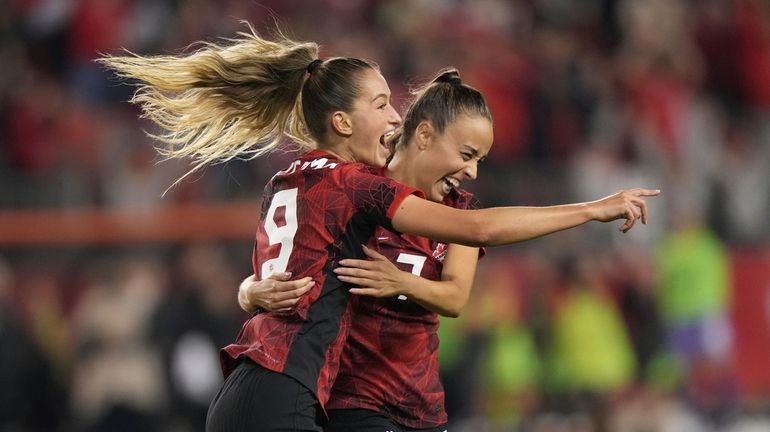 Canada's Jordyn Huitema (9) celebrates her goal with teammate Julia...