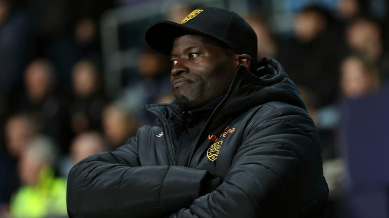Maidstone United manager George Elokobi appears dejected on the touchline...