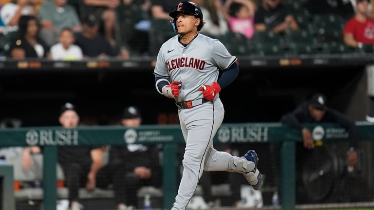 Cleveland Guardians' Bo Naylor runs the bases after hitting a...