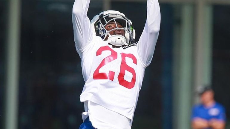 Giants running back Devin Singletary goes for a catch during training...