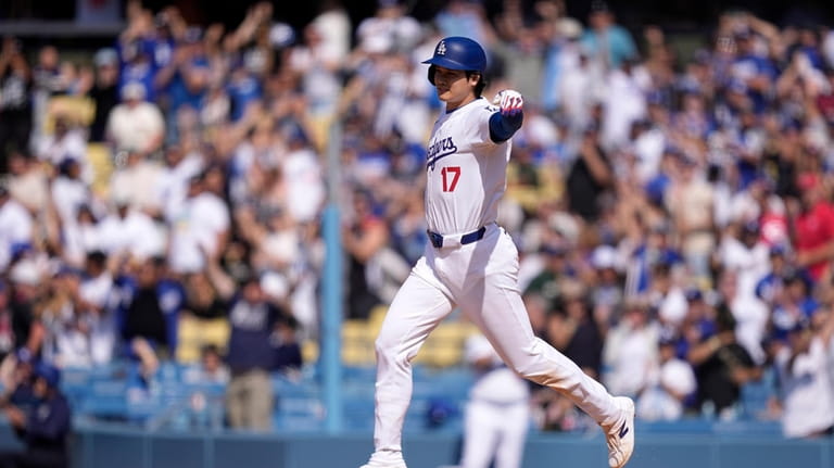 Los Angeles Dodgers' Shohei Ohtani celebrates after hitting a walk-off...
