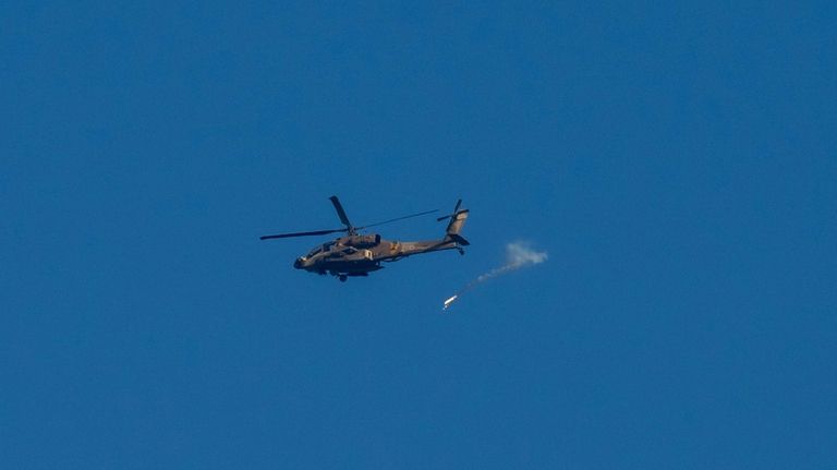 An Israeli military helicopter releases flares over the Israel-Gaza border...