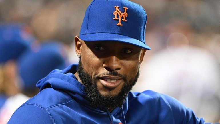 New York Mets Starling Marte looks on from the dugout...