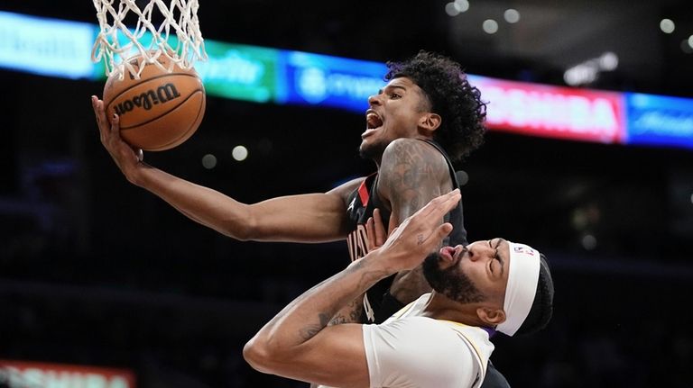 Houston Rockets guard Jalen Green, top, shoots as Los Angeles...