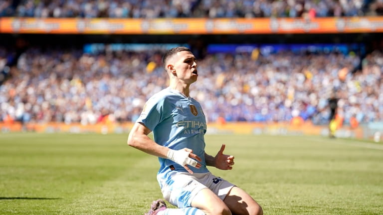 Manchester City's Phil Foden celebrates after scoring his side's opening...