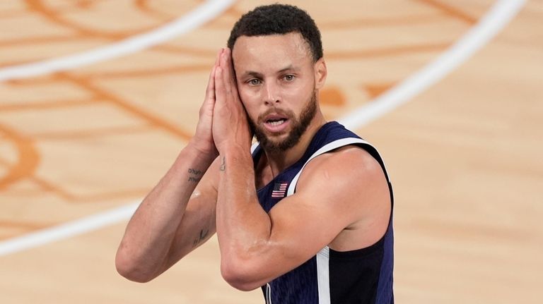 United States' Stephen Curry (4) reacts after a three-point basket...