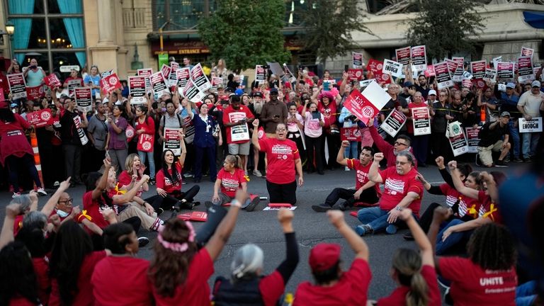 Members of the Culinary Workers Union block traffic along the...