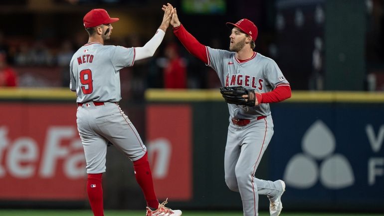 Los Angeles Angels' Zach Neto, left, and Taylor Ward celebrate...