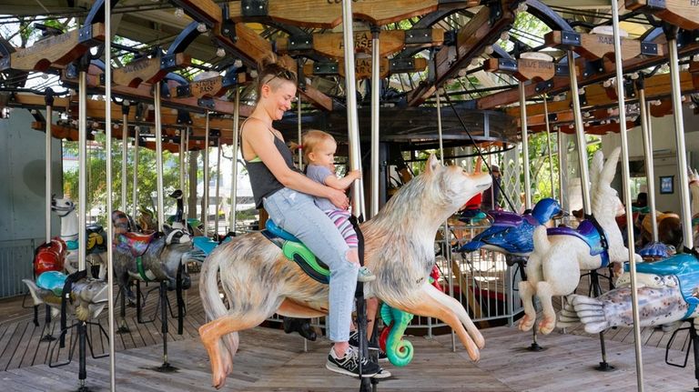 Families can ride hand-carved creatures at the Pier 62 carousel. 