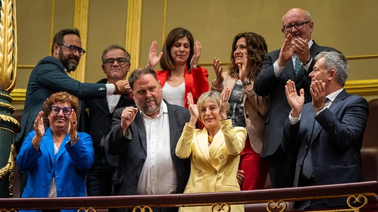 Catalan politicians Oriol Junqueras and Carme Forcadell, foreground and center,...