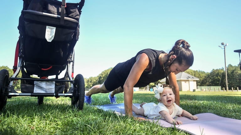 Lea Esposito, of Manorville, with her 4-month-old daughter Ruby, is...