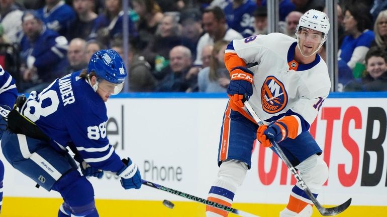 Islanders' Pierre Engvall (18) passes the puck as Toronto Maple...