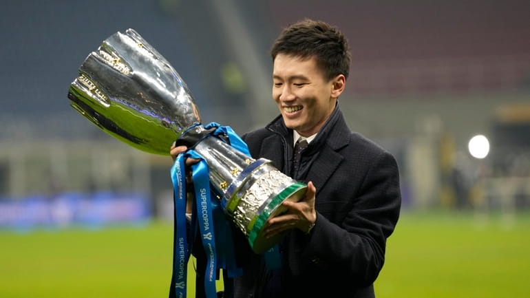 Inter Milan's President Steven Zhang smiles as he holds the...