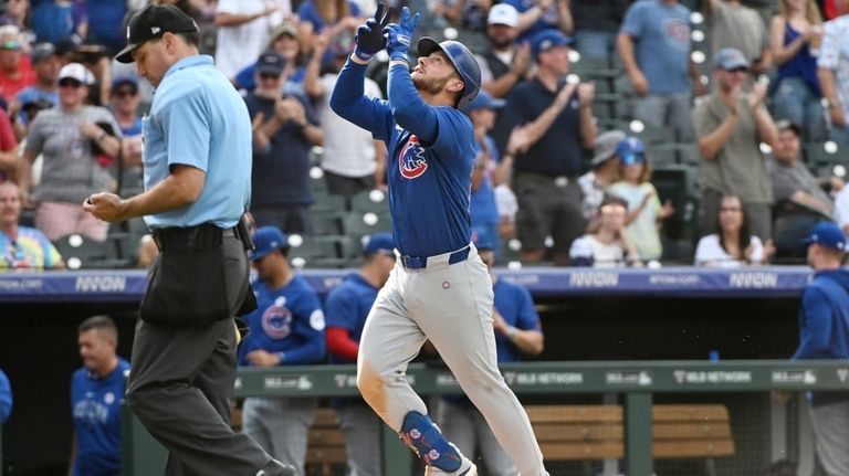 Chicago Cubs' Michael Busch celebrates while running the bases after...