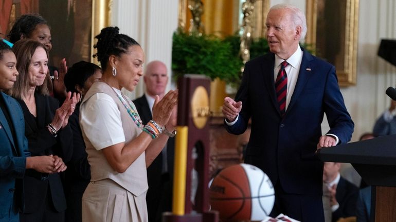 President Joe Biden speaks as the Coach of the University...