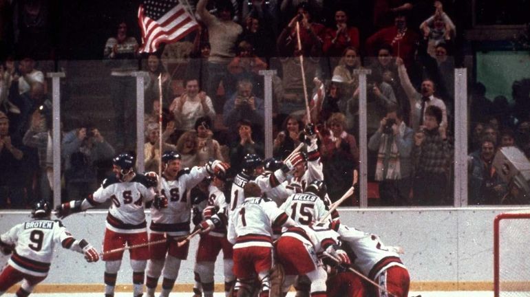 The U.S. hockey team pounces on goalie Jim Craig after...