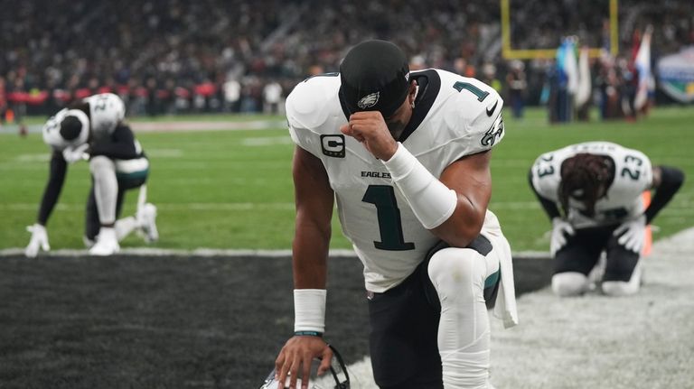 Philadelphia Eagles quarterback Jalen Hurts (1) prays before an NFL...