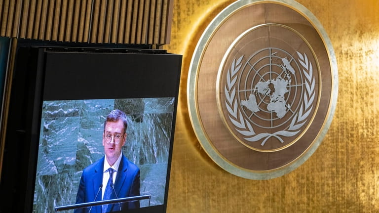Ukrainian Foreign Minister Dmytro Kuleba, displayed on a monitor, addresses...
