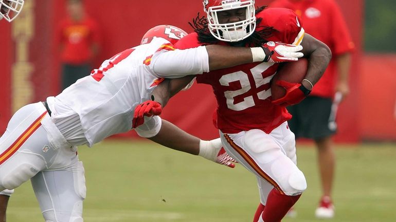 Kansas City Chiefs linebacker Nico Johnson tries to bring down...