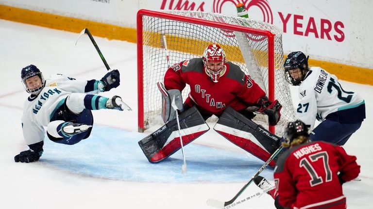 New York's Emma Woods, left, falls to the ice while...