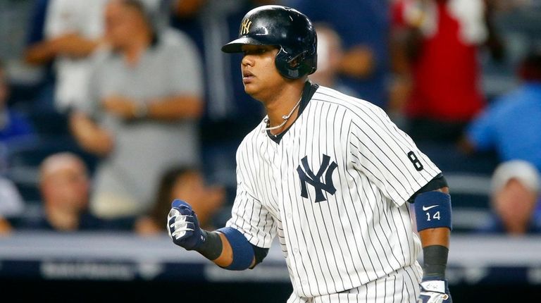 Starlin Castro #14 of the New York Yankees runs the...