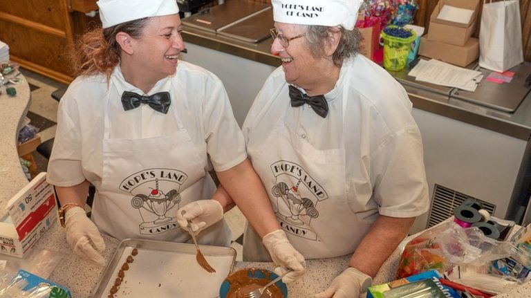 Joan Cohen, right, COO of Hope’s Land of Candy, working...