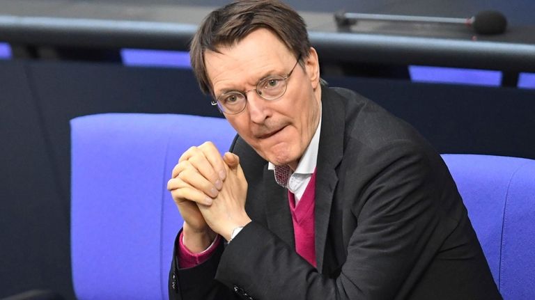 German Minister of Health Karl Lauterbach sits in the Bundestag...