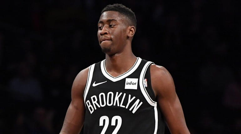 Nets guard Caris LeVert reacts after throwing the ball away...