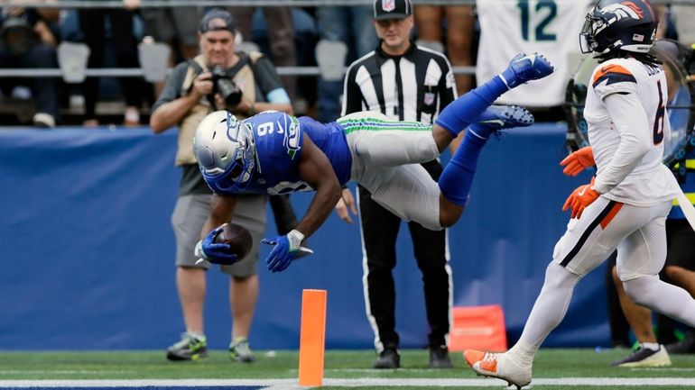 Seattle Seahawks running back Kenneth Walker III (9) leaps into...