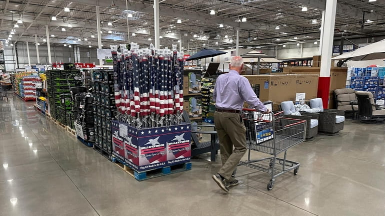 A shopper moves past a display of items in a...