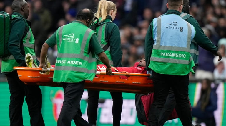 Liverpool's Ryan Gravenberch is stretchered off after an injury during...