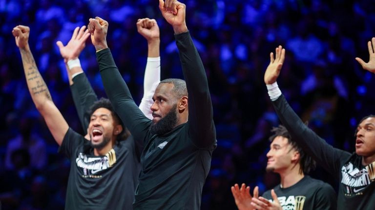 Los Angeles Lakers forward LeBron James, second from left, celebrates...