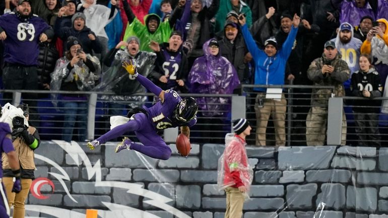 Baltimore Ravens punt returner Tylan Wallace celebrates his game-winning punt...