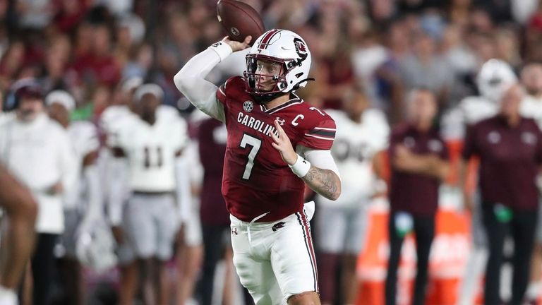 South Carolina quarterback Spencer Rattler (7) rolls out to pass...