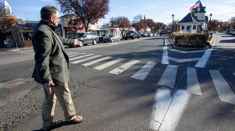 Amityville Mayor Dennis Siry takes a stroll recently in the village's...