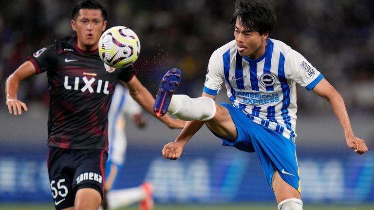 Brighton's Kaoru Mitoma, right, controls the ball as Kashima Antlers'...