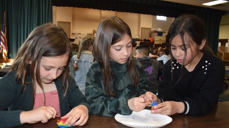 Third-graders recently practiced “unearthing” fossils from clay using such items...