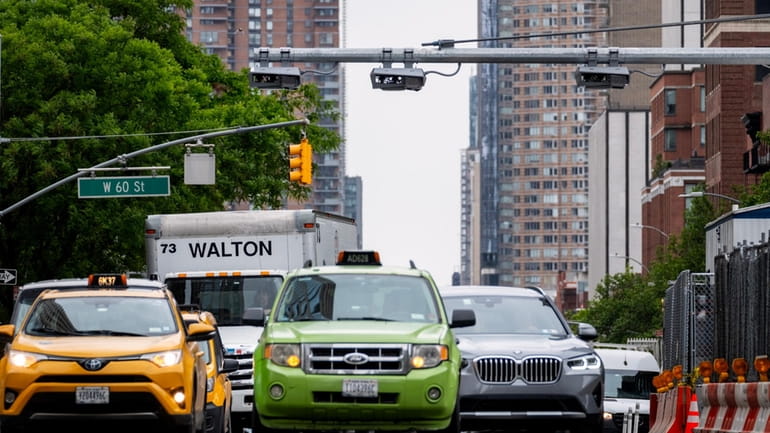 Congestion-pricing devices installed above traffic in Manhattan. The governor was...
