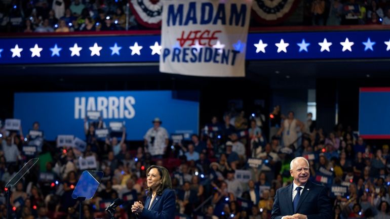 Democratic presidential nominee Vice President Kamala Harris and her running...