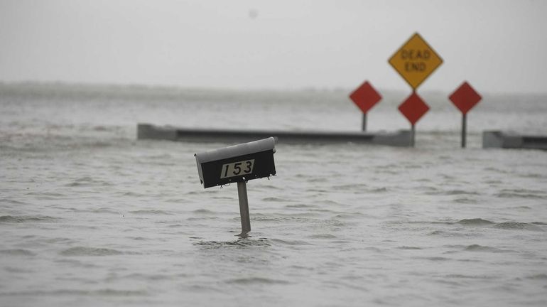 Water from Moriches Bay floods South Ocean Avenue and Inlet...