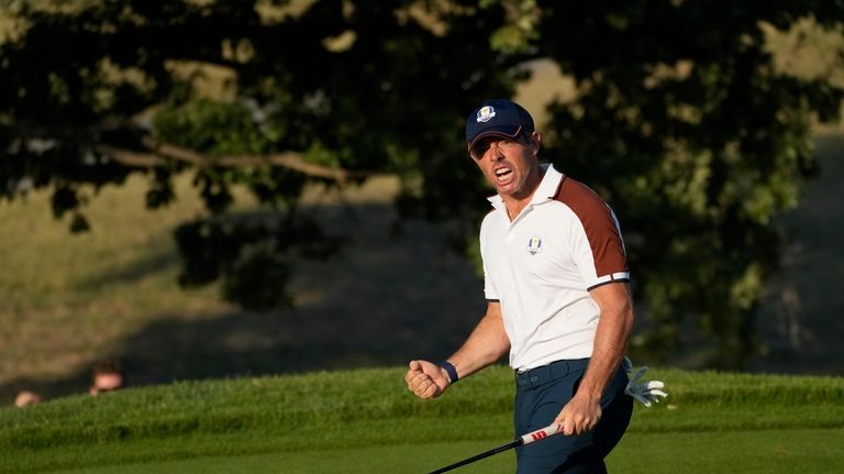 Europe's Rory Mcilroy celebrates on the 14th green during his...