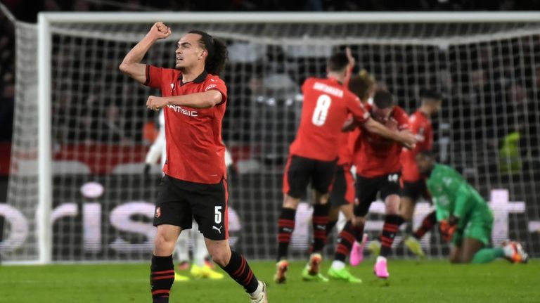 Rennes' Arthur Theate, left, celebrates a goal from his teammate...