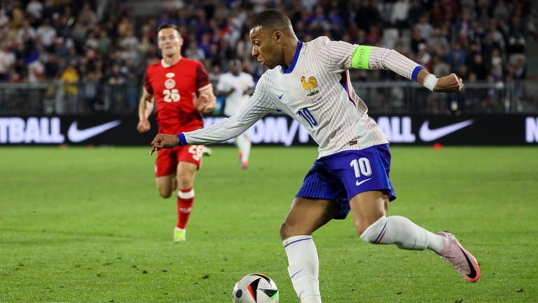 France's Kylian Mbappe controls the ball during the international friendly...