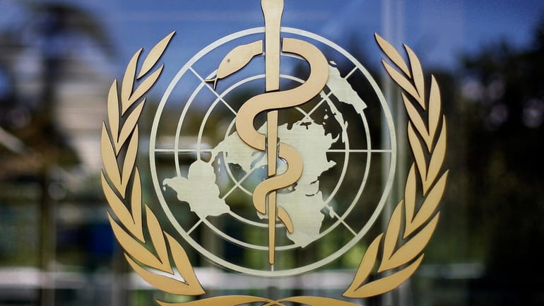 The logo of the World Health Organization is seen at...