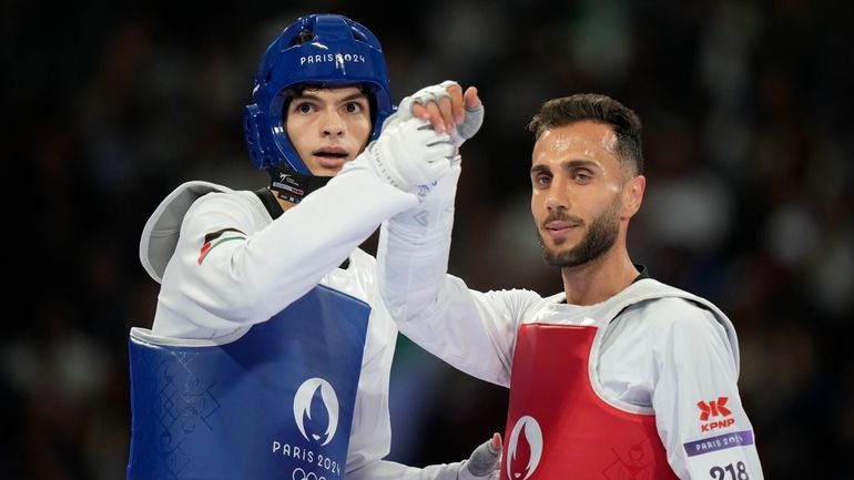 Palestine's Omar Yaser Ismail, left, competes with Refugees Olympic Team's...