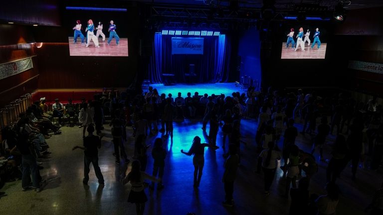 Teenagers dance to K-pop, popular Korean music, at a cultural...