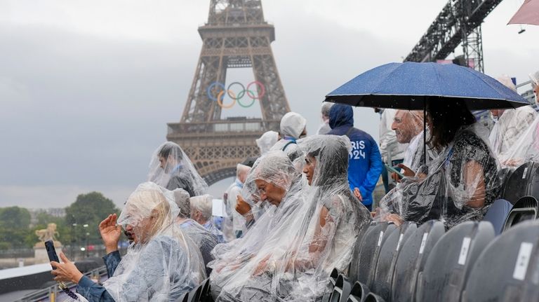 Spectators wait for the start of the opening ceremony of...