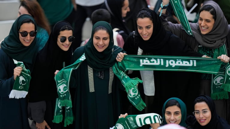 FILE - Saudi women supporters celebrate after Saudi Arabia won...