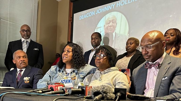 Arnitra Hollman, seated second from left, speaks during a news...