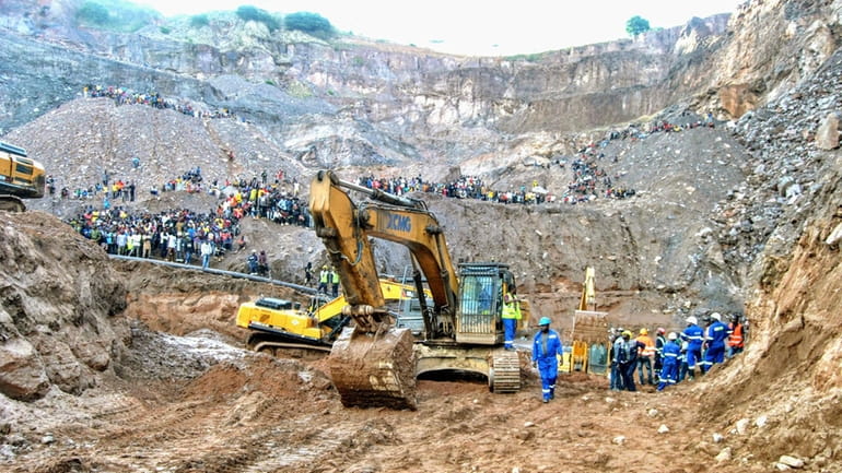 Excavators and people surround the scene of the miners rescue...
